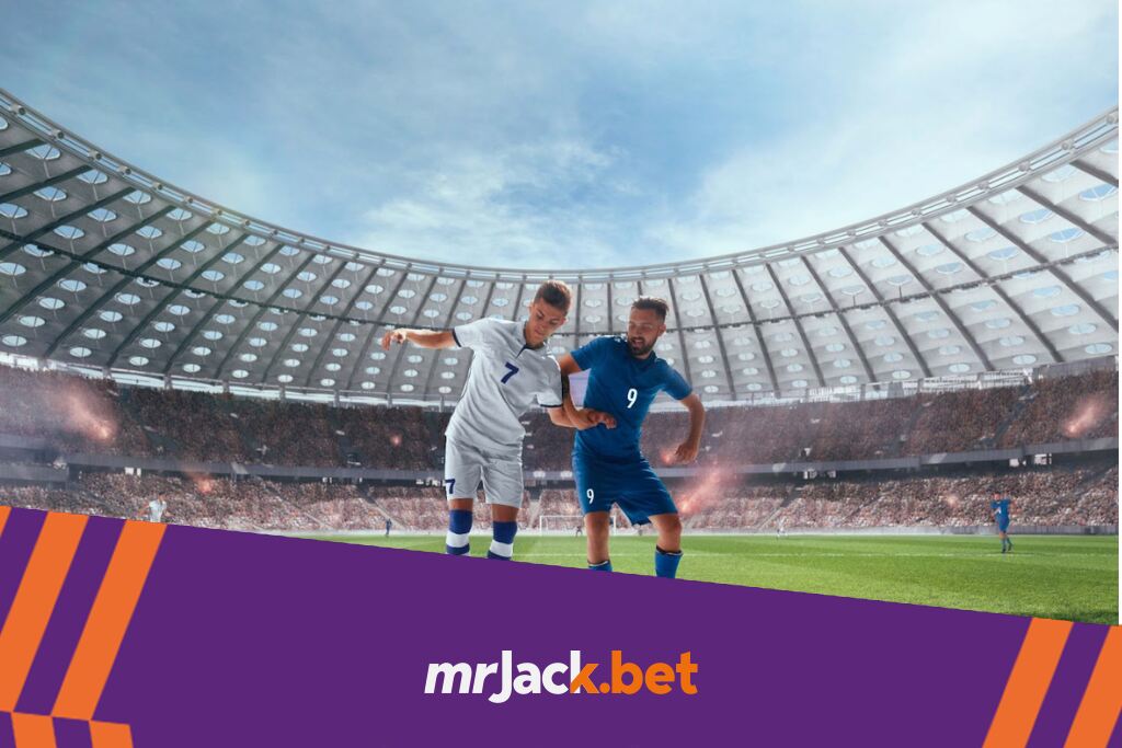 Dois jogadores de futebol, um de uniforme branco e outro de uniforme azul, disputando a bola no meio do campo.