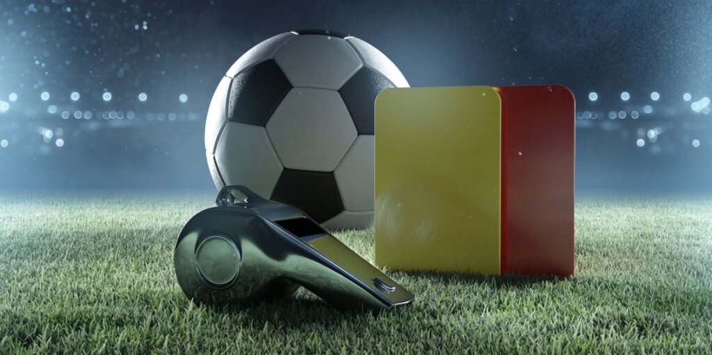 imagem gráfica de uma bola, um apito e dois cartões, representando as regras do futebol
